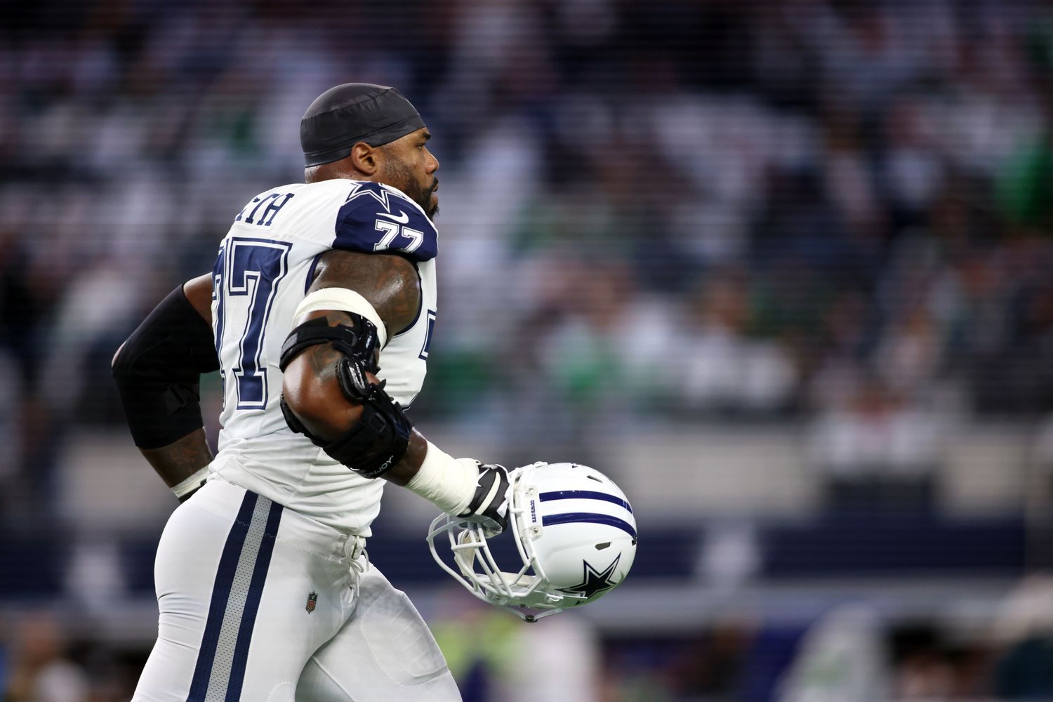 Dec 10, 2023; Arlington, Texas, USA; Dallas Cowboys offensive tackle Tyron Smith (77) runs off the field before the game against the Philadelphia Eagles at AT&T Stadium. Mandatory Credit: Tim Heitman-USA TODAY Sports  
